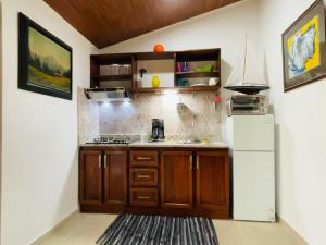 a kitchen with a sink, cabinets, and a window at Casa Donna Rosa B&B in Nuevo Arenal