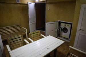 a room with a table and chairs and a washing machine at ECOPANA in Türkistan