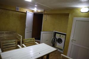 a kitchen with a white table and a washing machine at ECOPANA in Türkistan