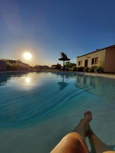 a person laying on the side of a swimming pool at Complejo "La Roca" - Cabañas y Hospedaje in Concepción del Uruguay