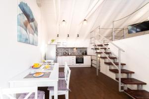 a kitchen and dining room with a white table and stairs at Casa Karina in Vis