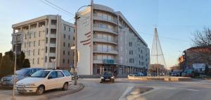 a white car parked in front of a building at Glambeauty1 in Jagodina