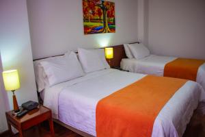 Postel nebo postele na pokoji v ubytování Hotel Sogamoso Real