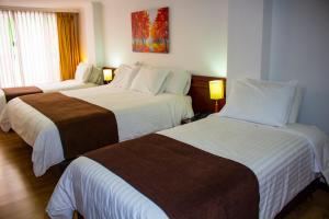 Postel nebo postele na pokoji v ubytování Hotel Sogamoso Real