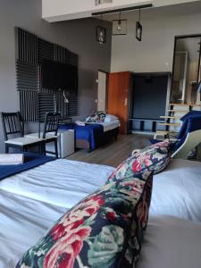 ザモシチにあるLoft Roomsのベッド2台、薄型テレビが備わる客室です。
