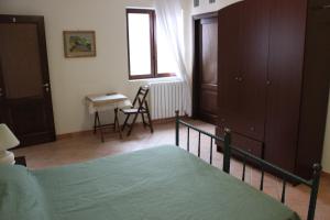 a bedroom with a bed and a table and a desk at B&B Villa Ursa Major in Vico Equense
