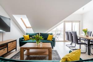 un salon avec un canapé vert et une table dans l'établissement Lux apartamenty Stara Polana, à Zakopane