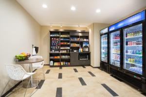 a tasting room with a large refrigerator and a table at Candlewood Suites Longmont - Boulder Area by IHG in Longmont