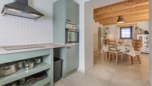 a kitchen with a table and a dining room at Villa Ive by Villas Holiday in Marčana