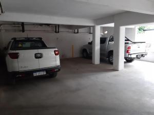 a parking garage with two cars parked in it at Departamento en Barrio Centrico Bariloche (PE) in San Carlos de Bariloche