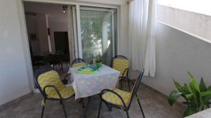 a table and chairs in a room with a window at Apartment Klimno 1 in Klimno