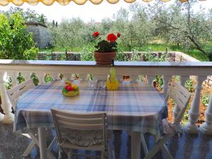 a table with a blue and white table cloth on a balcony at Apartments in Fazana/Istrien 8456 in Fažana