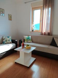 a living room with a couch and a table at Sunny Bay Apartments in Španjola