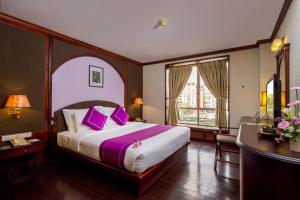 Postel nebo postele na pokoji v ubytování TTC Hotel - Da Lat