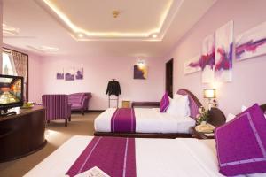 Postel nebo postele na pokoji v ubytování TTC Hotel - Da Lat