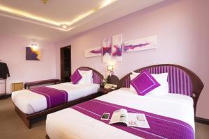 Postel nebo postele na pokoji v ubytování TTC Hotel - Da Lat