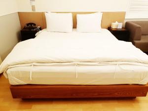 Postel nebo postele na pokoji v ubytování Uneed Hotel