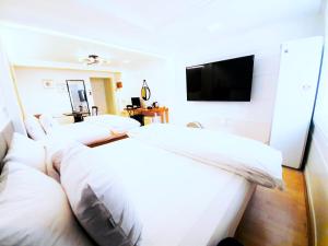Postel nebo postele na pokoji v ubytování Uneed Hotel