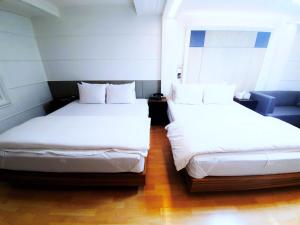 Postel nebo postele na pokoji v ubytování Uneed Hotel