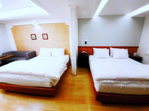 Postel nebo postele na pokoji v ubytování Uneed Hotel