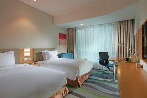 Postel nebo postele na pokoji v ubytování Holiday Inn Express Tangshan Downtown by IHG