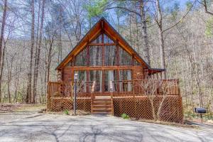 a log cabin in the middle of the woods at A Waterfall Retreat- Waterfall, Cozy Cabin Retreat in the Smokies Comfort & Fun for All in Sevierville