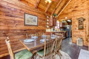 a wooden dining room with a table and chairs at A Waterfall Retreat- Waterfall, Cozy Cabin Retreat in the Smokies Comfort & Fun for All in Sevierville