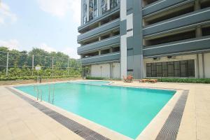a large swimming pool in front of a building at Apartemen Monroe Jababeka Cikarang Bekasi by Aparian in Bekasi