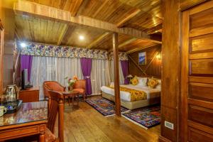 a bedroom with a bed and a desk in a room at Muscatel Himalayan Resort - 400 Mts from Mall Road in Darjeeling