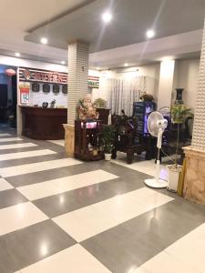 a store lobby with a checkered floor at Huyen Tran Hotel in Can Tho