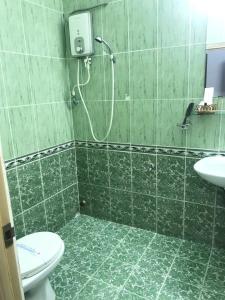 a bathroom with a shower and a toilet and a sink at Huyen Tran Hotel in Can Tho +37 photos