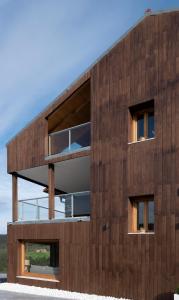 a wooden building with a balcony on it at Hotel Nafarrola - Gastronomy & Wine in Bermeo