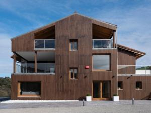 a wooden building with a lot of windows at Hotel Boutique Nafarrola in Bermeo