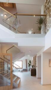 a staircase in a house with glass railing at Hotel Nafarrola - Gastronomy & Wine in Bermeo