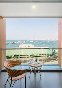 a dining room with a view of the ocean at Balihai Bay Pattaya in Pattaya South