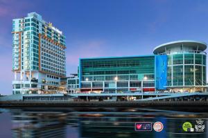 a city skyline with tall buildings and a river at Swiss-Belhotel Balikpapan in Balikpapan