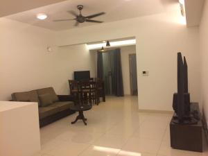 a living room with a couch and a ceiling fan at KL TOWER & KLCC VIEW HOTEL SUITE @ SUASANA BUKIT CEYLON BUKIT BINTANG in Kuala Lumpur