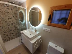 a bathroom with a sink and a toilet and a mirror at Casa Rural Manitoba Luxe in Buenache de la Sierra +45 photos