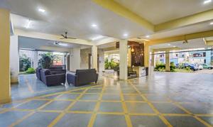 an empty lobby with couches and chairs in a building at Treebo Trend Kingsbury Fiesta Vellore in Vellore