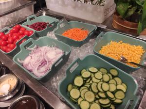 a counter with four trays of different types of vegetables at Holiday Inn Changzhou Wujin, an IHG Hotel in Changzhou