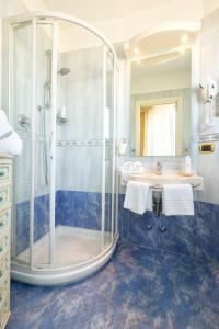 a bathroom with a shower and a sink at Hotel Baia Imperiale in Rimini