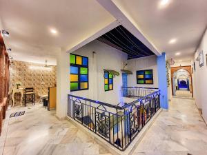 a room with a staircase with stained glass windows at Aura B&B - The Haveli Homestay in Jodhpur