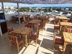 a group of tables and chairs on the roof of a restaurant at Hotel Best Apart in Istanbul