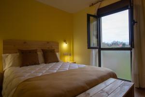 A bed or beds in a room at La Casona de Cardes