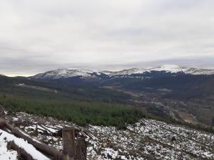a view of a valley with snow covered mountains at The White Stag Inn in Strathyre