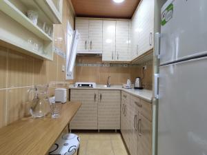 a kitchen with white cabinets and a refrigerator at Hotel Best Apart in Istanbul