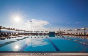 a large swimming pool with umbrellas on top of it at Hotel Admiral - by Liburnia Hotels & Villas in Opatija