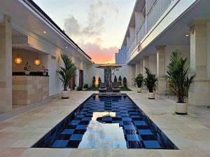 a swimming pool in the middle of a building at The Eight Bali - Seminyak in Seminyak