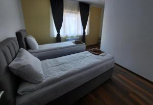 a living room with two beds and a couch at Wine cellar Popovi Apartments in Kavadarci