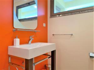 a bathroom with a white sink and a mirror at Charming Calheta Plaza Penthouse in Calheta +16 photos